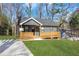 Charming home featuring a covered front porch and landscaped yard at 2019 Arlington Nw Cir, Atlanta, GA 30318