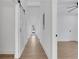 Bright hallway with light wood floors, white walls, and a sliding barn door to the left at 2019 Arlington Nw Cir, Atlanta, GA 30318