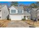 Two-story house with a white exterior, two-car garage, and front yard at 4260 Wesley Hall Dr, Decatur, GA 30035