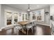 Bright dining area with farmhouse table and white chairs, leading to a covered patio at 4835 Sugar Maple Ln, Cumming, GA 30040