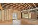 Unfinished basement with exposed framing, insulation, and double doors at 7519 Waterview Cv, Douglasville, GA 30135