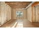 Unfinished basement room with exposed framing, insulation, and a window at 7519 Waterview Cv, Douglasville, GA 30135