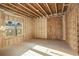 Unfinished basement room with exposed framing, insulation, and a window at 7519 Waterview Cv, Douglasville, GA 30135