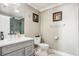 Modern bathroom with gray vanity, hexagon tile shower, and white toilet at 7519 Waterview Cv, Douglasville, GA 30135