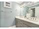 Bathroom with dual vanity, gray cabinets, and quartz countertop at 7519 Waterview Cv, Douglasville, GA 30135