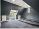 Large bonus room with sloped ceilings and built-in stage at 7519 Waterview Cv, Douglasville, GA 30135