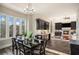 Bright dining area with a view, hardwood floors, and a black dining table at 7519 Waterview Cv, Douglasville, GA 30135