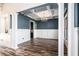 Formal dining room with hardwood floors, wainscoting, and a tray ceiling at 7519 Waterview Cv, Douglasville, GA 30135