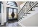 Elegant entryway with double doors, a grand staircase, and intricate railing at 7519 Waterview Cv, Douglasville, GA 30135