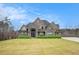 Two-story home with stone and brick exterior, and a manicured lawn at 7519 Waterview Cv, Douglasville, GA 30135