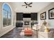 Sunlit Gathering room features a stone fireplace, built-in cabinets, and hardwood floors at 7519 Waterview Cv, Douglasville, GA 30135