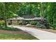 Ranch style home nestled in a wooded setting with a long driveway at 220 Mountain Pt, Roswell, GA 30075