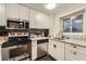 Modern kitchen with stainless steel appliances and granite countertops at 300 W Peachtree St # 12A, Atlanta, GA 30308