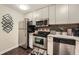 Updated kitchen, featuring stainless steel appliances and granite countertops at 300 W Peachtree St # 12A, Atlanta, GA 30308