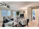 Bright living room with sectional sofa, balcony access, and hardwood floors at 300 W Peachtree St # 12A, Atlanta, GA 30308