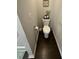 Small bathroom with toilet and dark wood flooring at 3109 Baylor Cir, Mcdonough, GA 30253