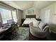 Bedroom with a queen-size bed, home office setup, and circular chair at 3109 Baylor Cir, Mcdonough, GA 30253