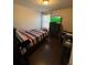 Bedroom with striped bedding, TV, and built-in desk area at 3109 Baylor Cir, Mcdonough, GA 30253