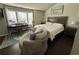 Bright bedroom with a king-size bed, workspace, and a comfy lounge chair at 3109 Baylor Cir, Mcdonough, GA 30253