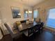 Dining area with a dark wood table, gray chairs, and access to the backyard at 3109 Baylor Cir, Mcdonough, GA 30253