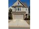Two-story house with gray siding, brick accents, and a two-car garage at 3109 Baylor Cir, Mcdonough, GA 30253
