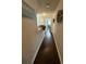 Long hallway with dark hardwood floors and stylish wall decor at 3109 Baylor Cir, Mcdonough, GA 30253