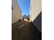 Narrow side yard with patchy grass between houses at 3109 Baylor Cir, Mcdonough, GA 30253