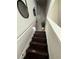 Modern staircase with dark wood treads and neutral wall colors at 3109 Baylor Cir, Mcdonough, GA 30253