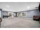 Finished basement recreation room with grey walls and carpet at 5195 Hamby Rd, Acworth, GA 30102