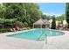 Community pool with lounge chairs and covered seating at 1106 Firethorne Pass, Cumming, GA 30040