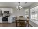 Kitchen boasts white cabinets, stainless steel appliances and a dining area at 1920 Hampton Walk Ct, Hoschton, GA 30548