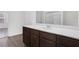 Well-lit bathroom featuring a white countertop vanity and a view of the shower area at 4770 Marco Ln, Cumming, GA 30028