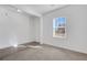 White bedroom has neutral carpet and a window to let in natural light at 4770 Marco Ln, Cumming, GA 30028