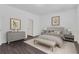 Stylishly furnished bedroom with wood floors, tufted headboard, and neutral decor at 4770 Marco Ln, Cumming, GA 30028
