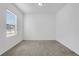 Bright bedroom with neutral carpet and ample natural light from a window at 4770 Marco Ln, Cumming, GA 30028