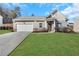 Charming single-story home featuring a two-car garage, manicured lawn, and inviting front entrance at 4770 Marco Ln, Cumming, GA 30028