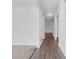Long, white hallway with dark floors and light colored carpet at 4770 Marco Ln, Cumming, GA 30028