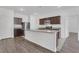 Kitchen boasts an island, stainless steel appliances and ample countertop space at 4770 Marco Ln, Cumming, GA 30028