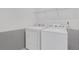 Laundry room with side-by-side washer and dryer beneath a wire shelf for storing detergent at 4770 Marco Ln, Cumming, GA 30028