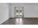 Bright, open-concept living room with wood floors and glass doors leading to the patio at 4770 Marco Ln, Cumming, GA 30028