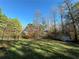 Spacious backyard with large trees and a storage shed at 2051 Irwin Bridge Nw Rd, Conyers, GA 30012