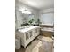 Double vanity bathroom with marble countertops and soaking tub at 2051 Irwin Bridge Nw Rd, Conyers, GA 30012