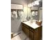 Bathroom boasts a wood vanity, updated fixtures and stylish decor at 2051 Irwin Bridge Nw Rd, Conyers, GA 30012