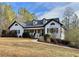 White farmhouse exterior with wraparound porch and landscaped yard at 2051 Irwin Bridge Nw Rd, Conyers, GA 30012