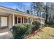 Side view of the house with a porch, green lawn and bushes at 52 Jennifer Ln, Carrollton, GA 30116