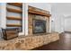 Stone fireplace with built-in shelving and wood storage at 52 Jennifer Ln, Carrollton, GA 30116