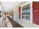 Front porch with wooden flooring, white railings and red shutters at 52 Jennifer Ln, Carrollton, GA 30116