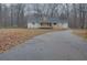 Long driveway leading to a charming house nestled in trees at 5520 Hearn Rd, Ellenwood, GA 30294