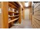 Hallway with wood walls, flooring, and shelving at 5520 Hearn Rd, Ellenwood, GA 30294