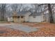 View of a light beige ranch home with a porch and driveway at 5520 Hearn Rd, Ellenwood, GA 30294